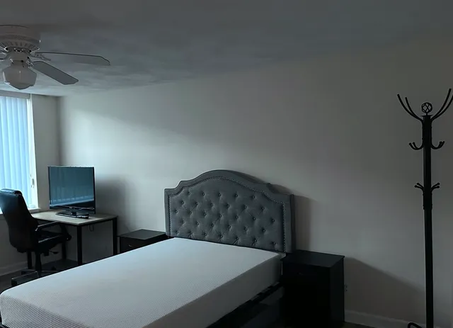 a bedroom with a bed and a tv on table