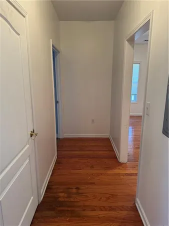 a view of a hallway with wooden floor
