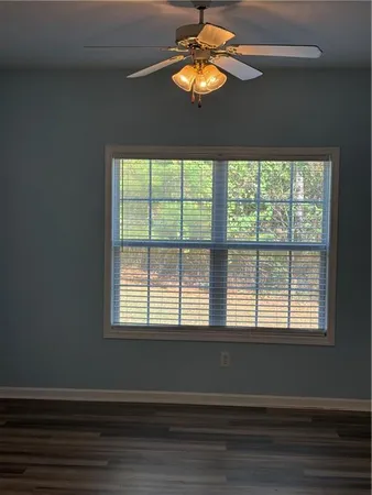 a view of a chandelier fan and wooden floor