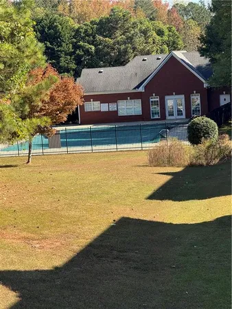 a view of a house with pool and a yard