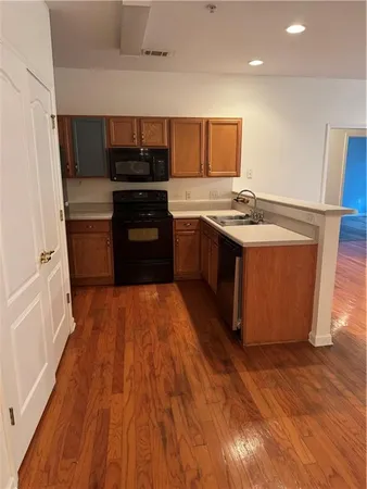 a large kitchen with stainless steel appliances granite countertop a stove and a refrigerator