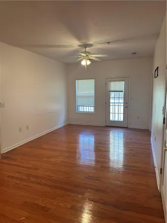 a view of livingroom with hardwood floor and a ceiling fan
