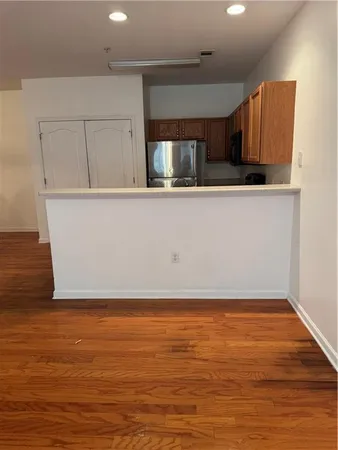 a view of room with window and wooden floor