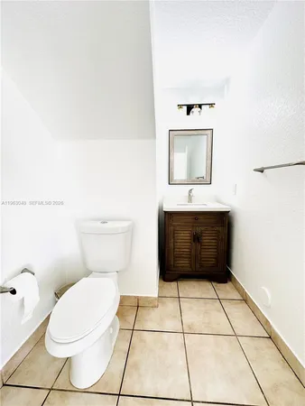 a bathroom with a toilet a sink and mirror