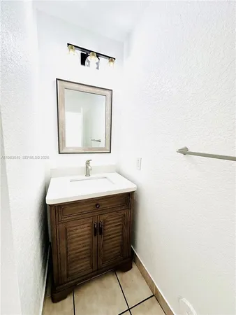 a view of a bathroom with a sink and a mirror