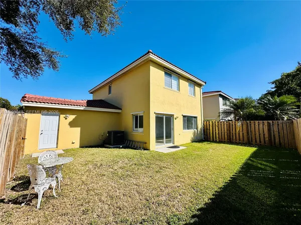a front view of house with yard outdoor seating and barbeque oven