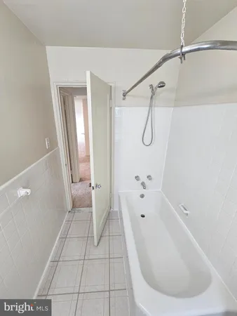 a bathroom with a bathtub and shower
