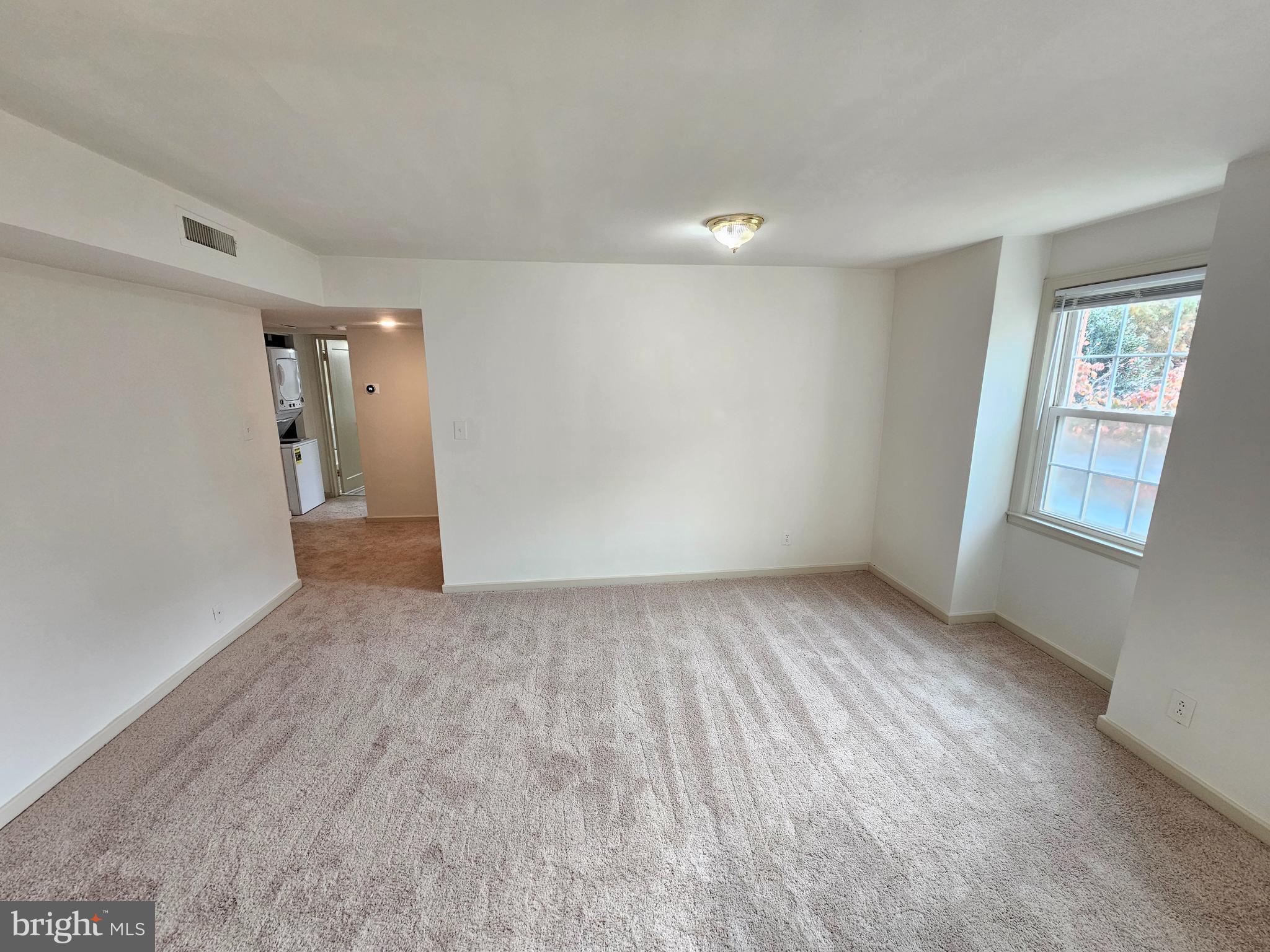 2205 Washington Avenue, Unit 201 Silver Spring, MD 20910 - Photo 4 of 20 wooden floor in an empty room with a window