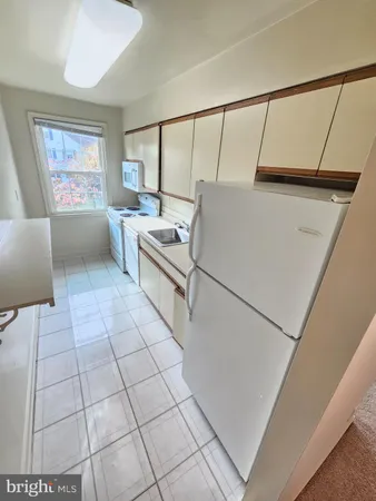 a living room with a couch and a stove top oven