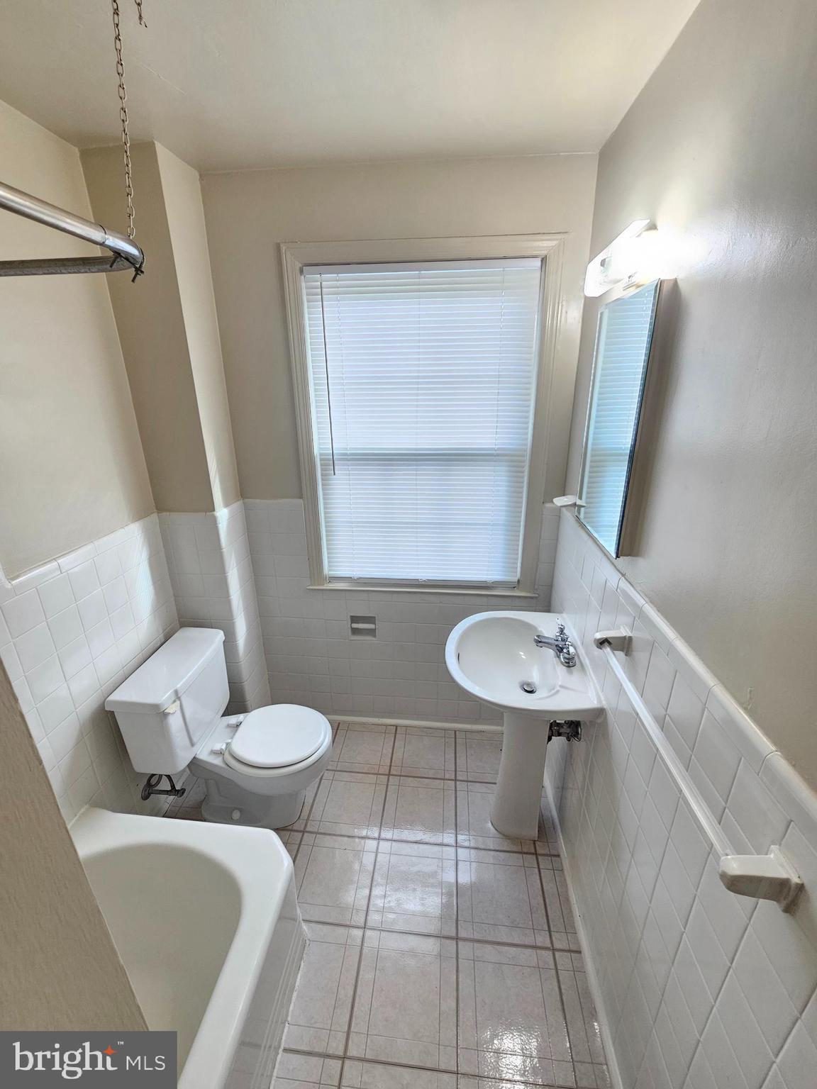 2205 Washington Avenue, Unit 201 Silver Spring, MD 20910 - Photo 10 of 20 a bathroom with a toilet sink and mirror