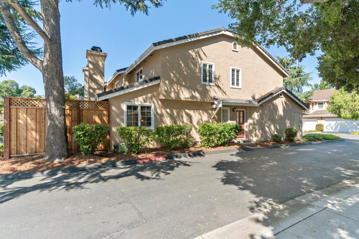 145 Redding Road Campbell, CA 95008 - Photo 1 of 22 a view of a white house with a large windows and a yard with plants