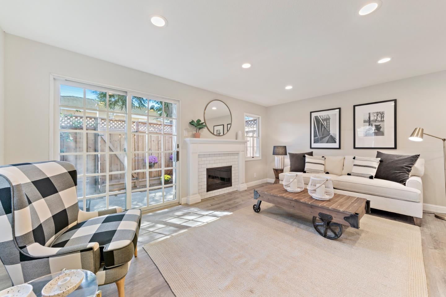 145 Redding Road Campbell, CA 95008 - Photo 11 of 22 a living room with furniture a fireplace and a floor to ceiling window