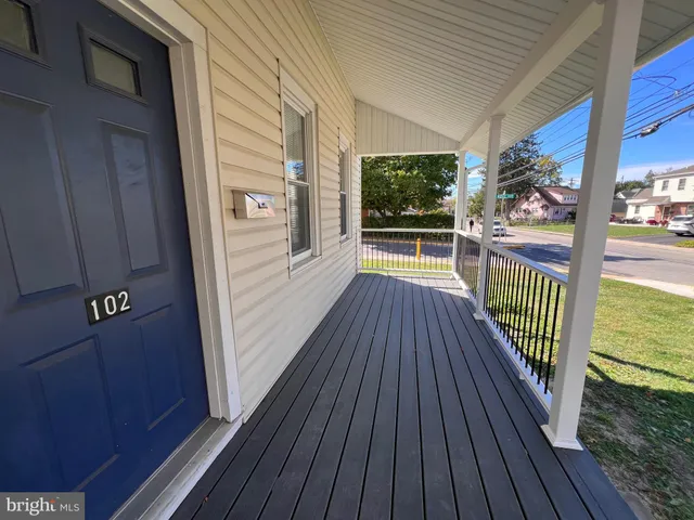a view of a balcony with wooden floor