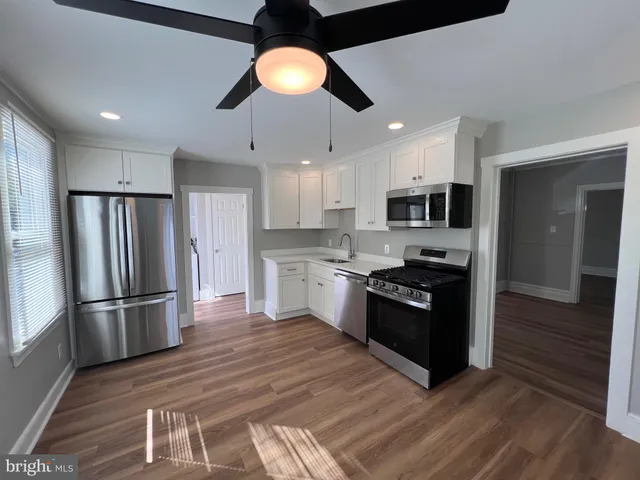 a kitchen with stainless steel appliances granite countertop a refrigerator a stove top oven a sink and dishwasher