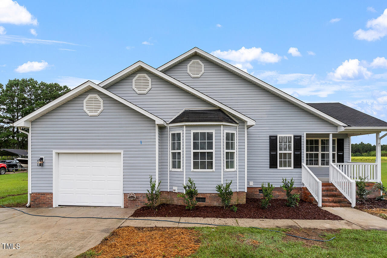 2127 Bainbridge Road Stedman, NC 28391 - Photo 1 of 27 a front view of a house with a yard
