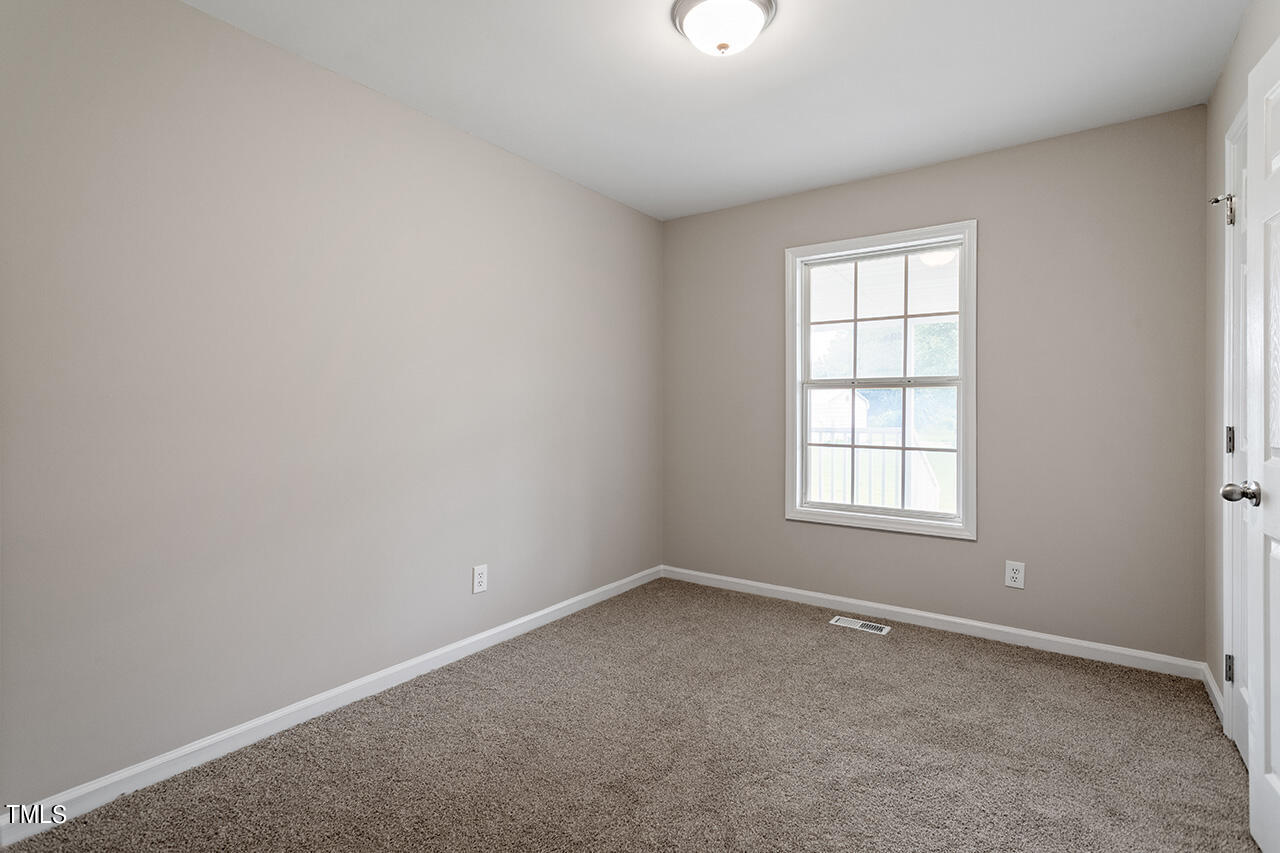 2127 Bainbridge Road Stedman, NC 28391 - Photo 19 of 27 an empty room with a window