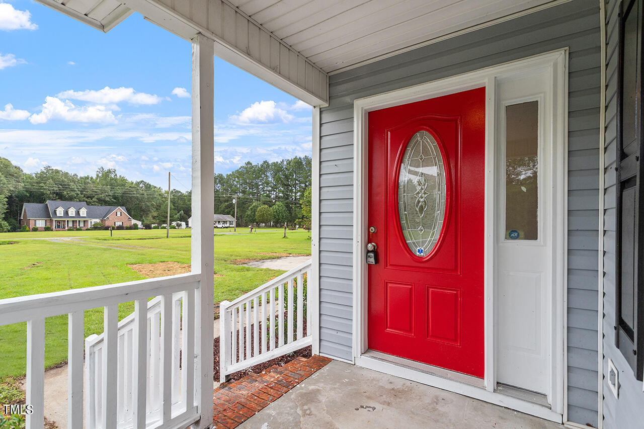 2127 Bainbridge Road Stedman, NC 28391 - Photo 26 of 27 a view of a red door with a red door and side view of the porch