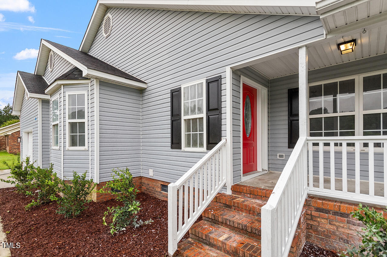 2127 Bainbridge Road Stedman, NC 28391 - Photo 27 of 27 a view of a house with large windows and flower plants