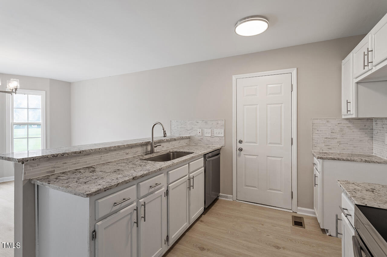 2127 Bainbridge Road Stedman, NC 28391 - Photo 4 of 27 a kitchen with sink stove and cabinets