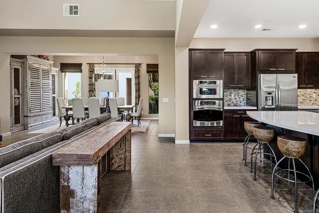 a kitchen with stainless steel appliances granite countertop a stove refrigerator and cabinets