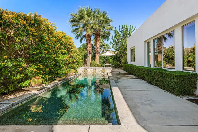 a backyard of a house with yard and outdoor seating