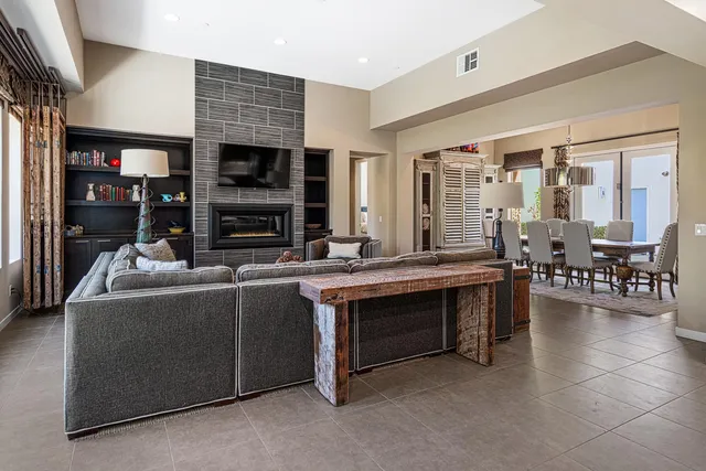 a living room with furniture a flat screen tv and a fireplace