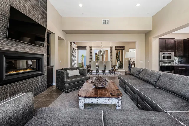 a living room with furniture flat screen tv and a fireplace