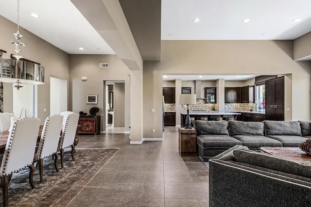 a living room with furniture and a dining table with kitchen view