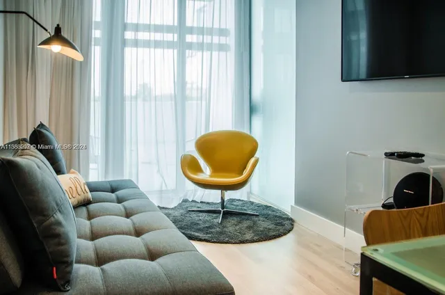 a living room with furniture and a mirror
