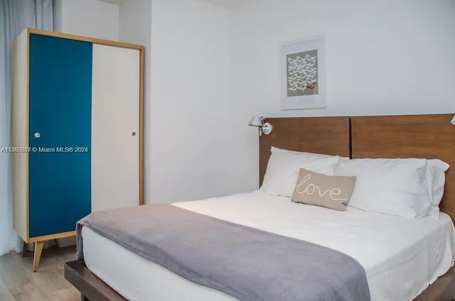 a bedroom with a bed and a wall painting