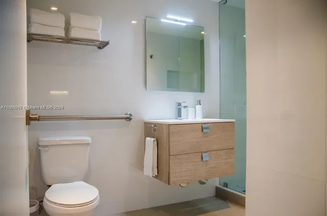 a bathroom with a sink toilet and mirror