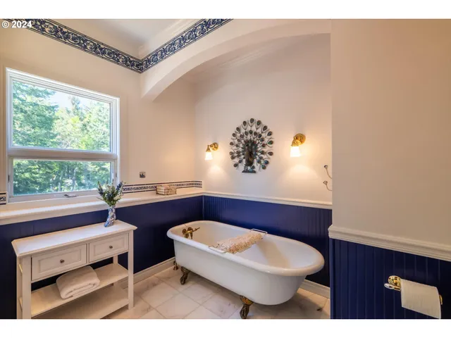 a living room with furniture a large window with kitchen view