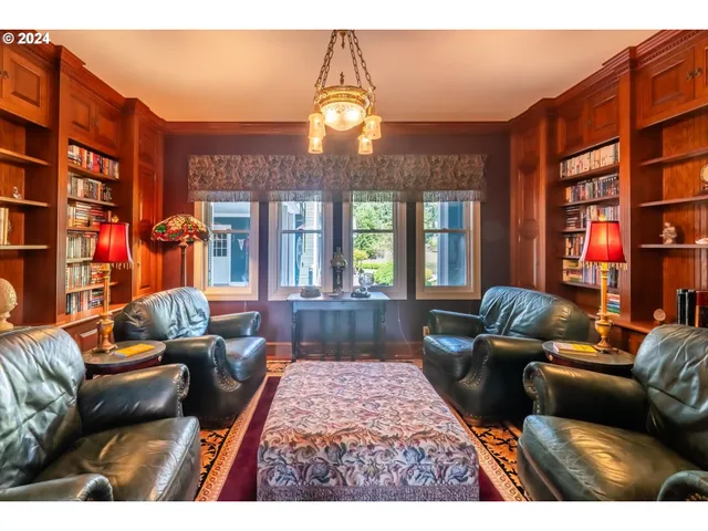 a living room with couches and a dining table with wooden floor