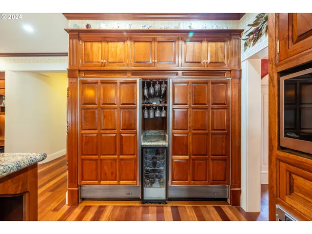 a kitchen with stainless steel appliances granite countertop a stove and a wooden cabinets