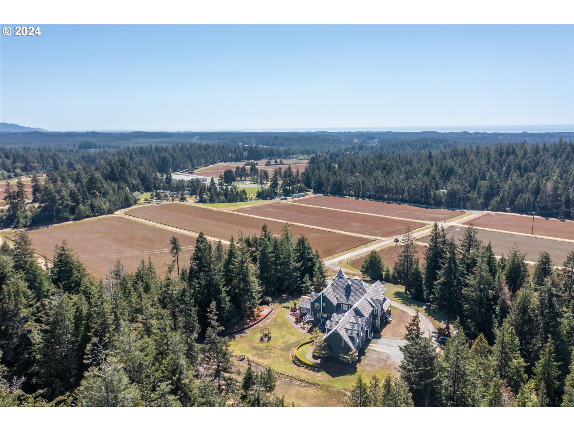 54980 Morrison Road Bandon, OR 97411 - Photo 36 of 48 a view of a house with a yard