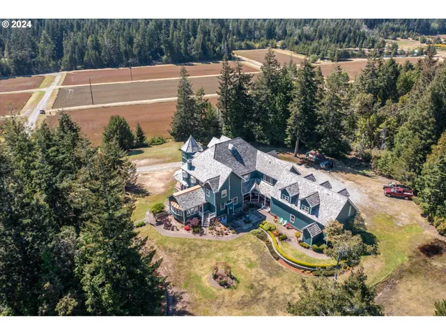 an aerial view of a house with yard swimming pool and outdoor seating