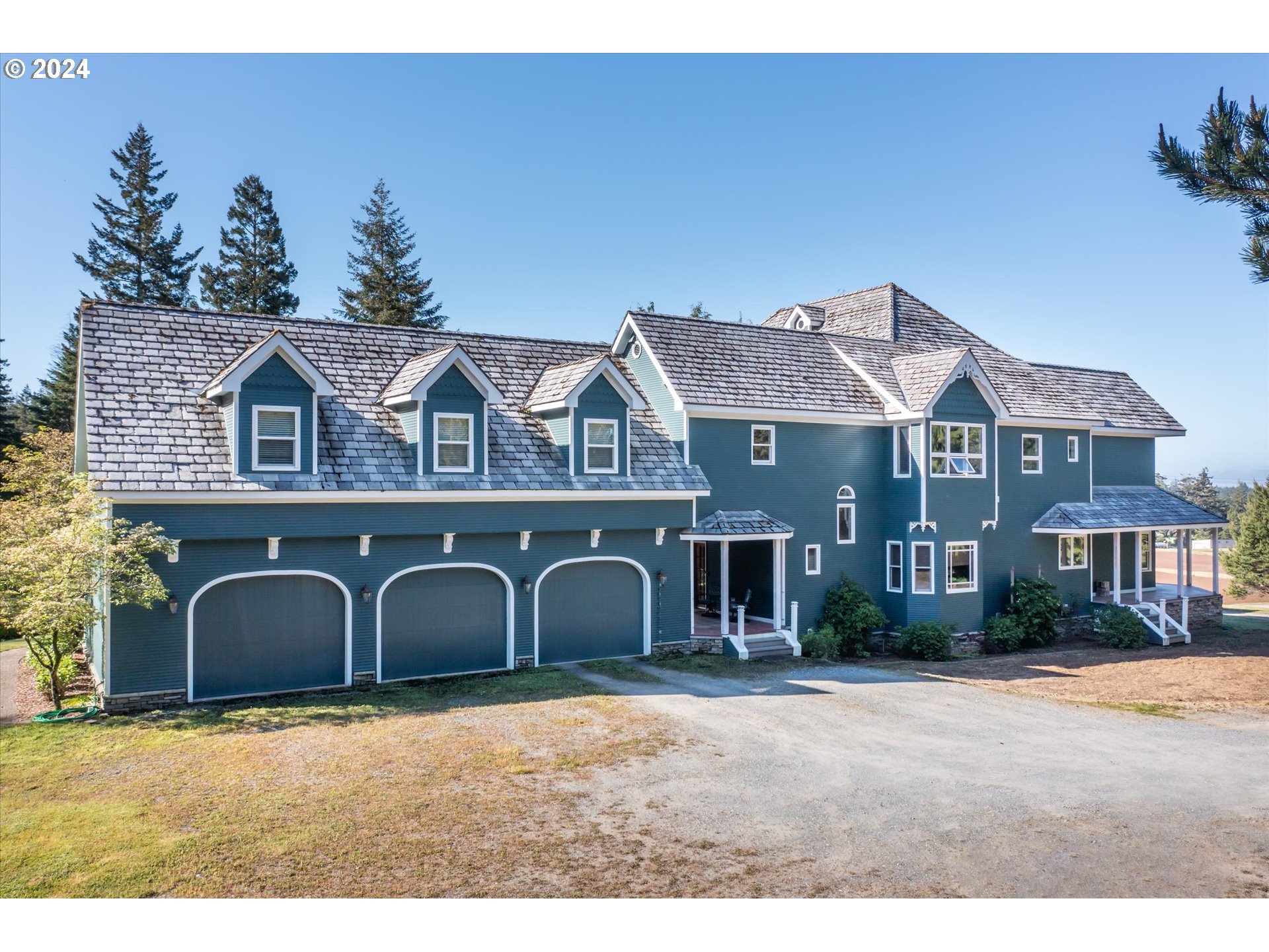 54980 Morrison Road Bandon, OR 97411 - Photo 5 of 48 a front view of a house with garden