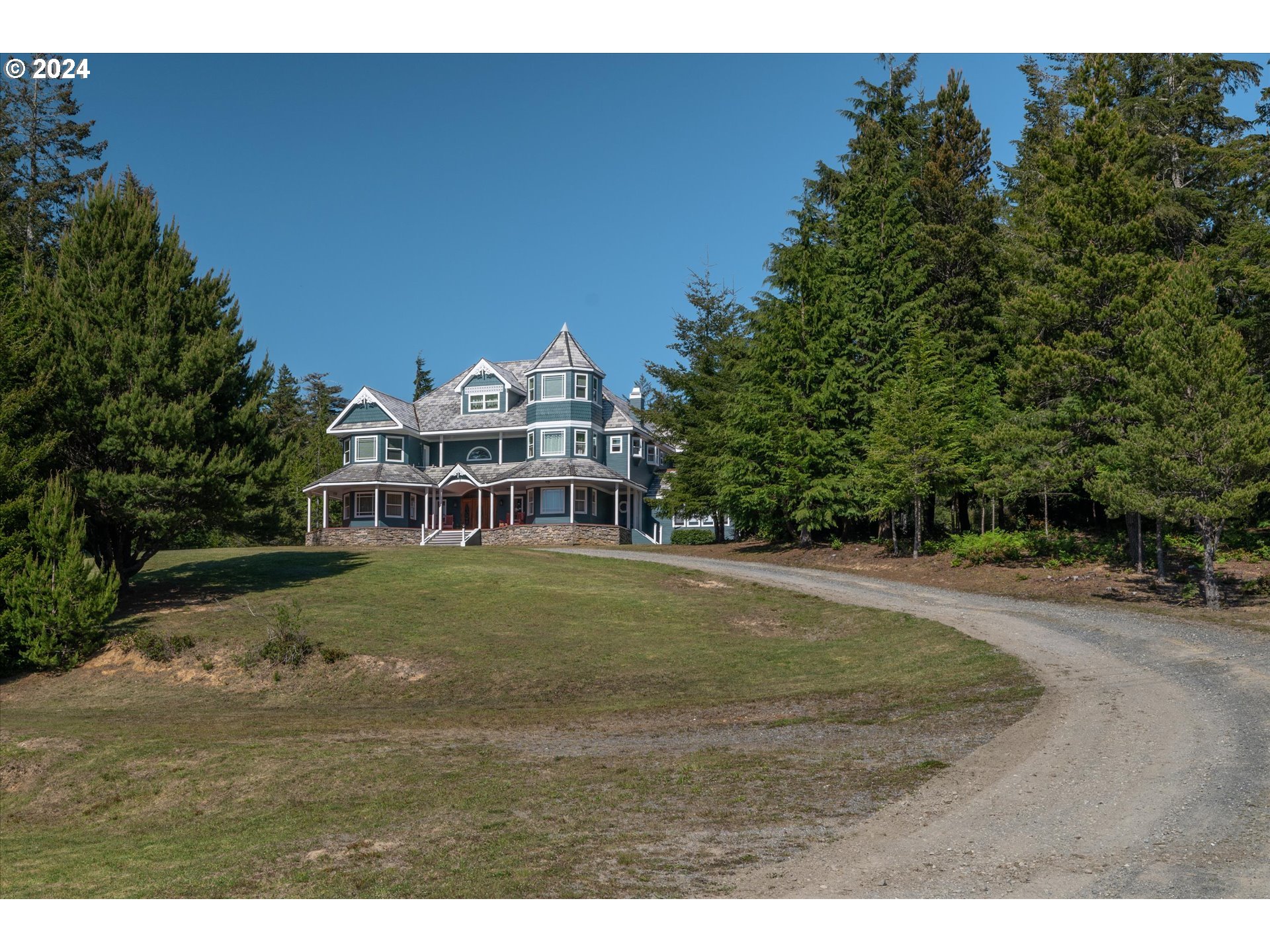 54980 Morrison Road Bandon, OR 97411 - Photo 6 of 48 a front view of a house with a garden