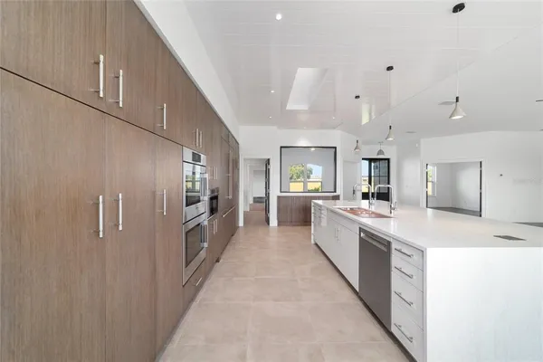 a view of empty room with wooden floor and windows