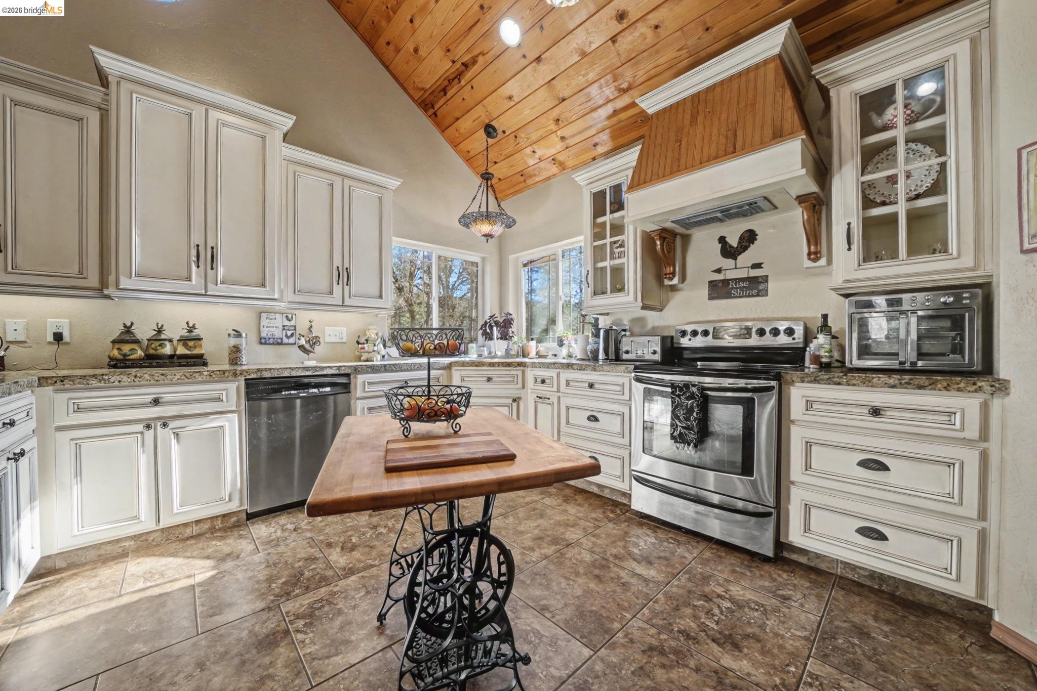 6145 Swiss Ranch Road Mountain Ranch, CA 95246 - Photo 14 of 60 a kitchen with appliances a stove and cabinets