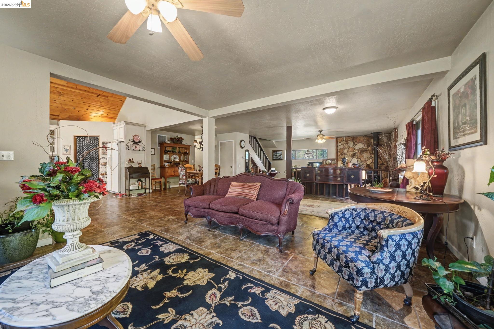 6145 Swiss Ranch Road Mountain Ranch, CA 95246 - Photo 19 of 60 Living room featuring a ceiling fan and a textured ceiling