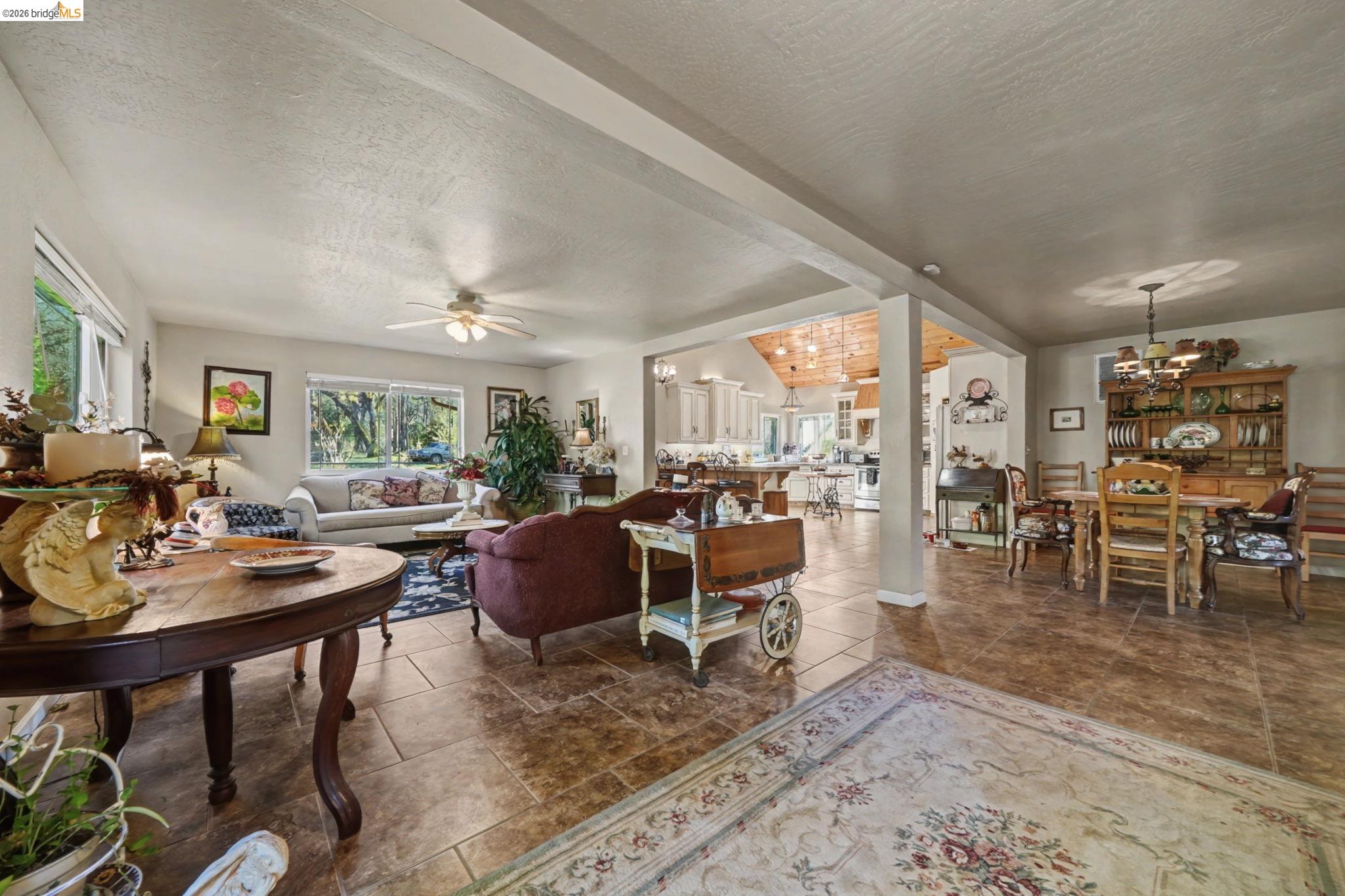 6145 Swiss Ranch Road Mountain Ranch, CA 95246 - Photo 23 of 60 Living room with suspended lighting, ceiling fan, and beamed ceiling