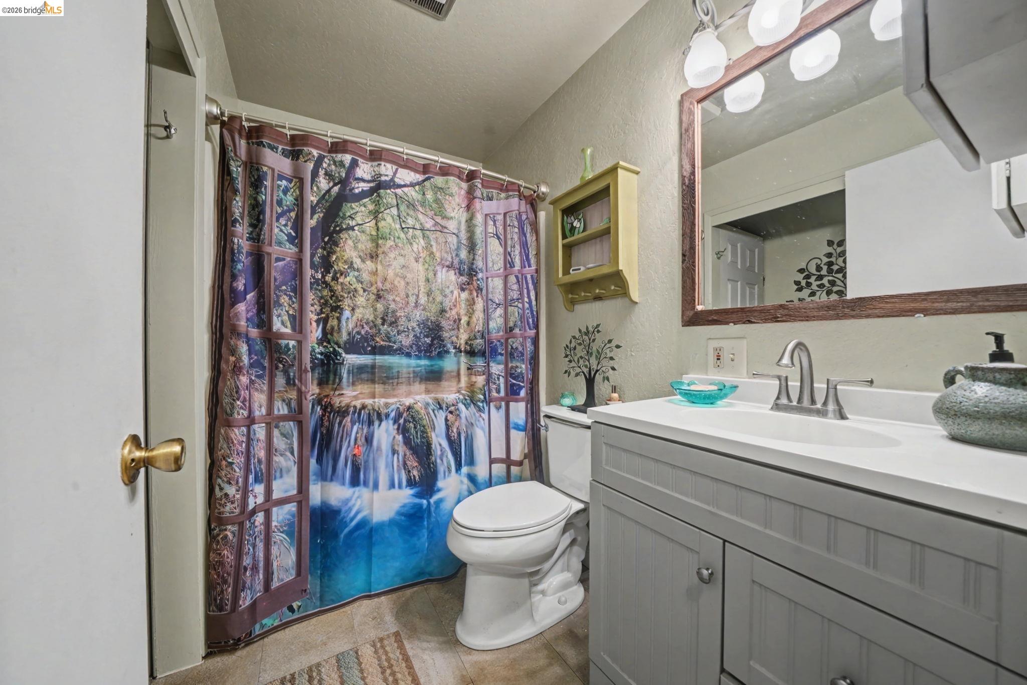 6145 Swiss Ranch Road Mountain Ranch, CA 95246 - Photo 30 of 60 Full bath with a textured wall, vanity, curtained shower, and a textured ceiling