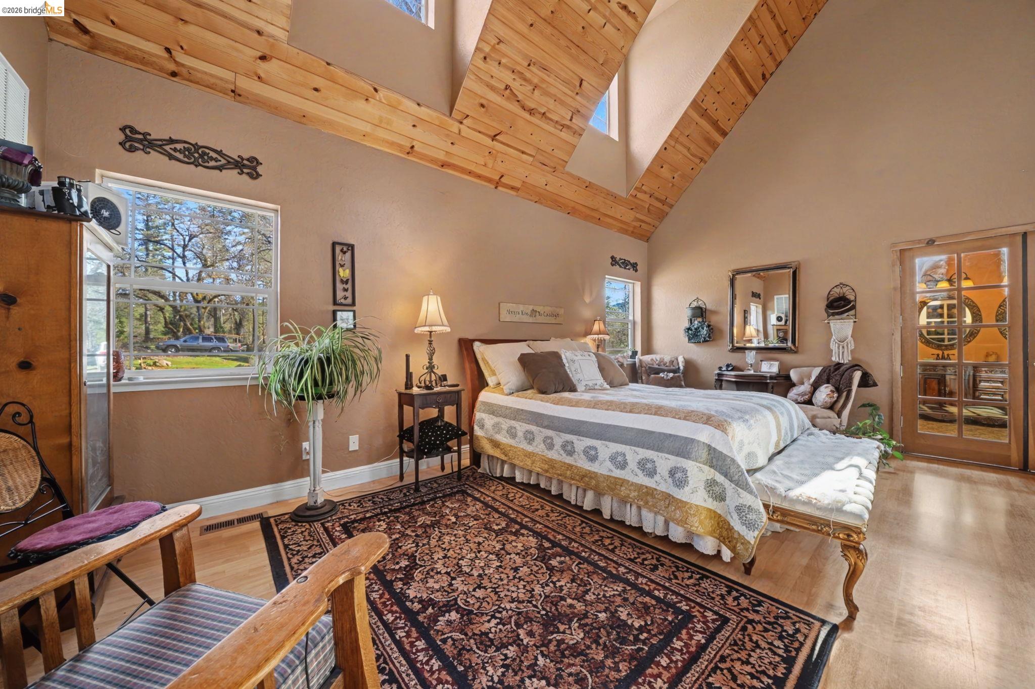 6145 Swiss Ranch Road Mountain Ranch, CA 95246 - Photo 32 of 60 Bedroom with light wood-style flooring, a skylight, access to exterior, and vaulted ceiling