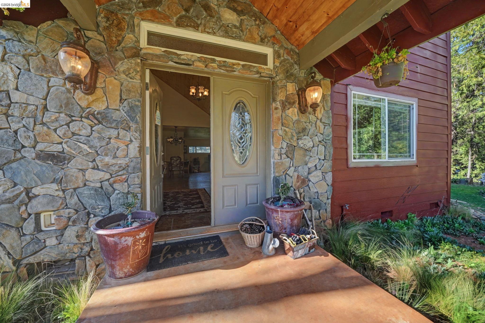6145 Swiss Ranch Road Mountain Ranch, CA 95246 - Photo 10 of 60 View of exterior entry with stone siding and crawl space