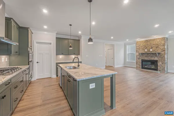 a kitchen with sink stove and refrigerator