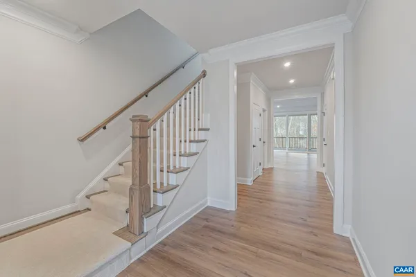 a view of an entryway with wooden floor and staircase