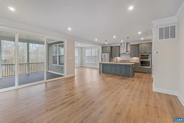 a view of a kitchen with wooden floor and a window