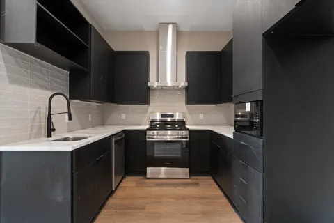 a kitchen with stainless steel appliances a sink stove and refrigerator