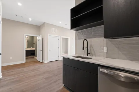 a kitchen with a sink and a mirror